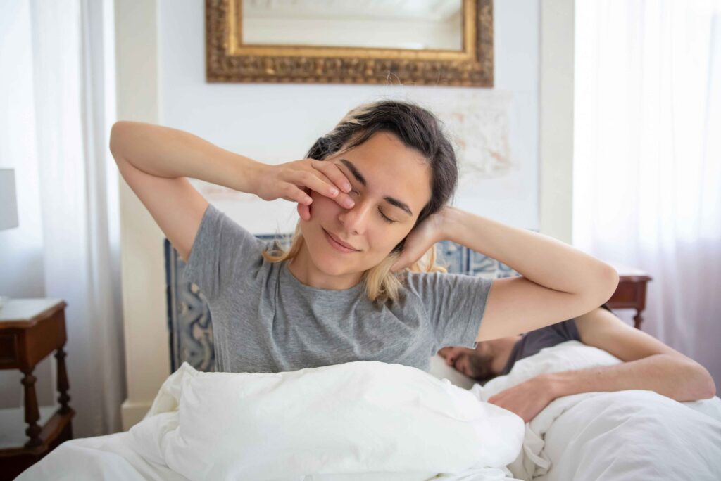 a woman waking up and rubbing her eyes.  5am club