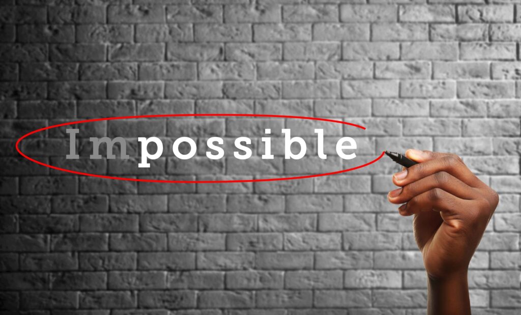 the word impossible on a brick wall circled in red.  the im is faded so it says clearly possible