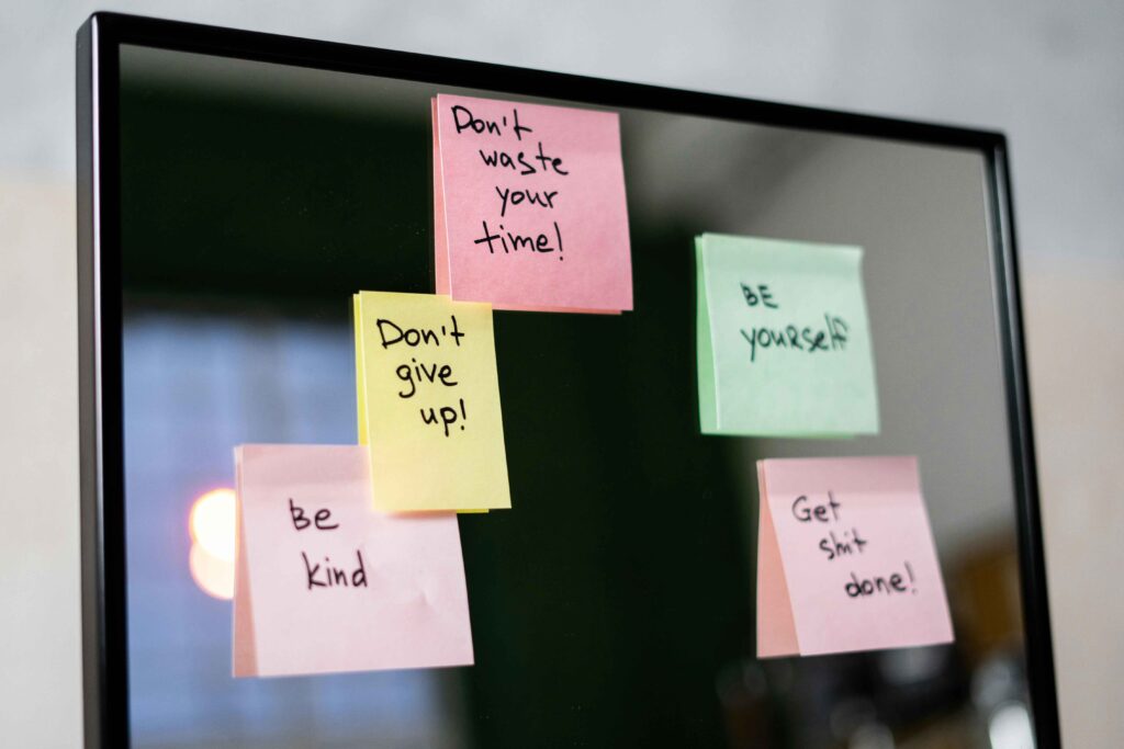 pastel stickie notes with postive affirmations on a tv