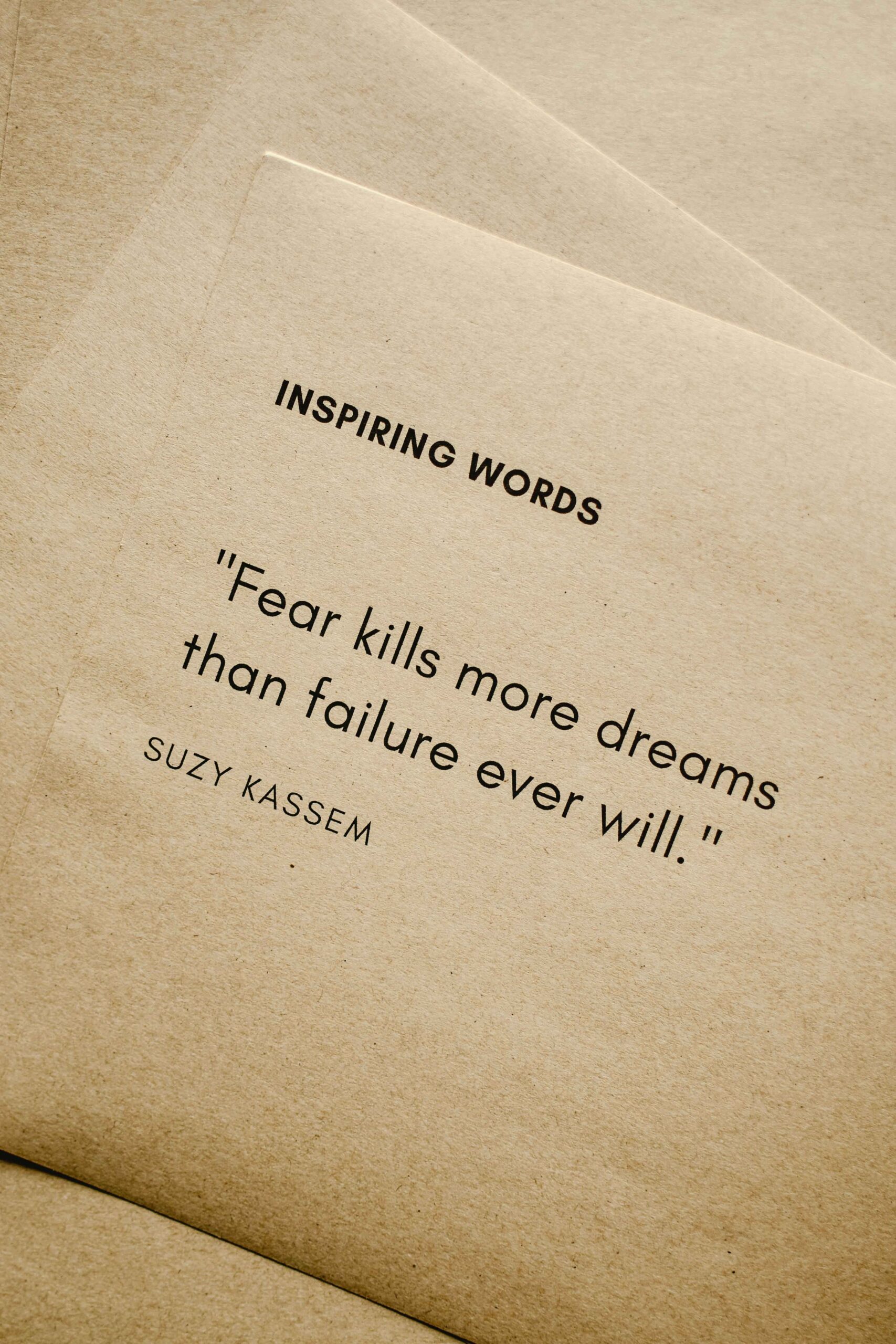 success quote "fear kills more dreams than failure ever did" on a piece of paper typed.