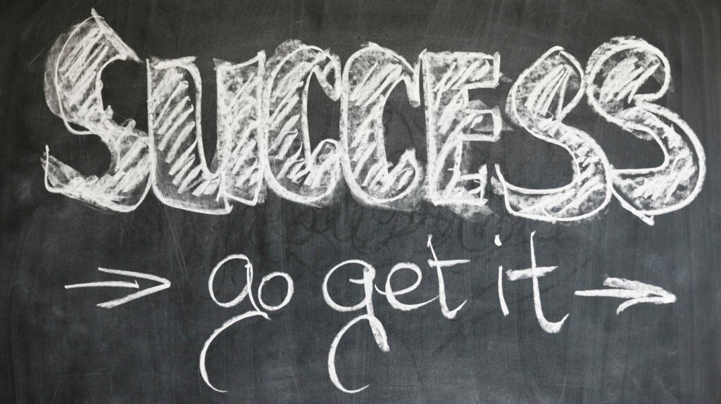 the quote "success go get it" in white chalk on a black chalkboard.  entrepreneur mindset