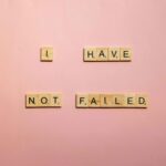 scrabble tiles on a pink background they say"I have not failed" think like a CEO