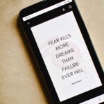 overcoming fear of failure. phone screen with the words "fear kills more dreams than failure ever will"