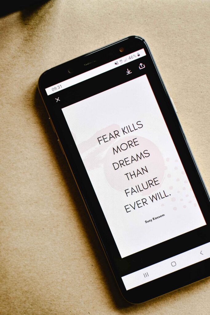 overcoming fear of failure. phone screen with the words "fear kills more dreams than failure ever will"