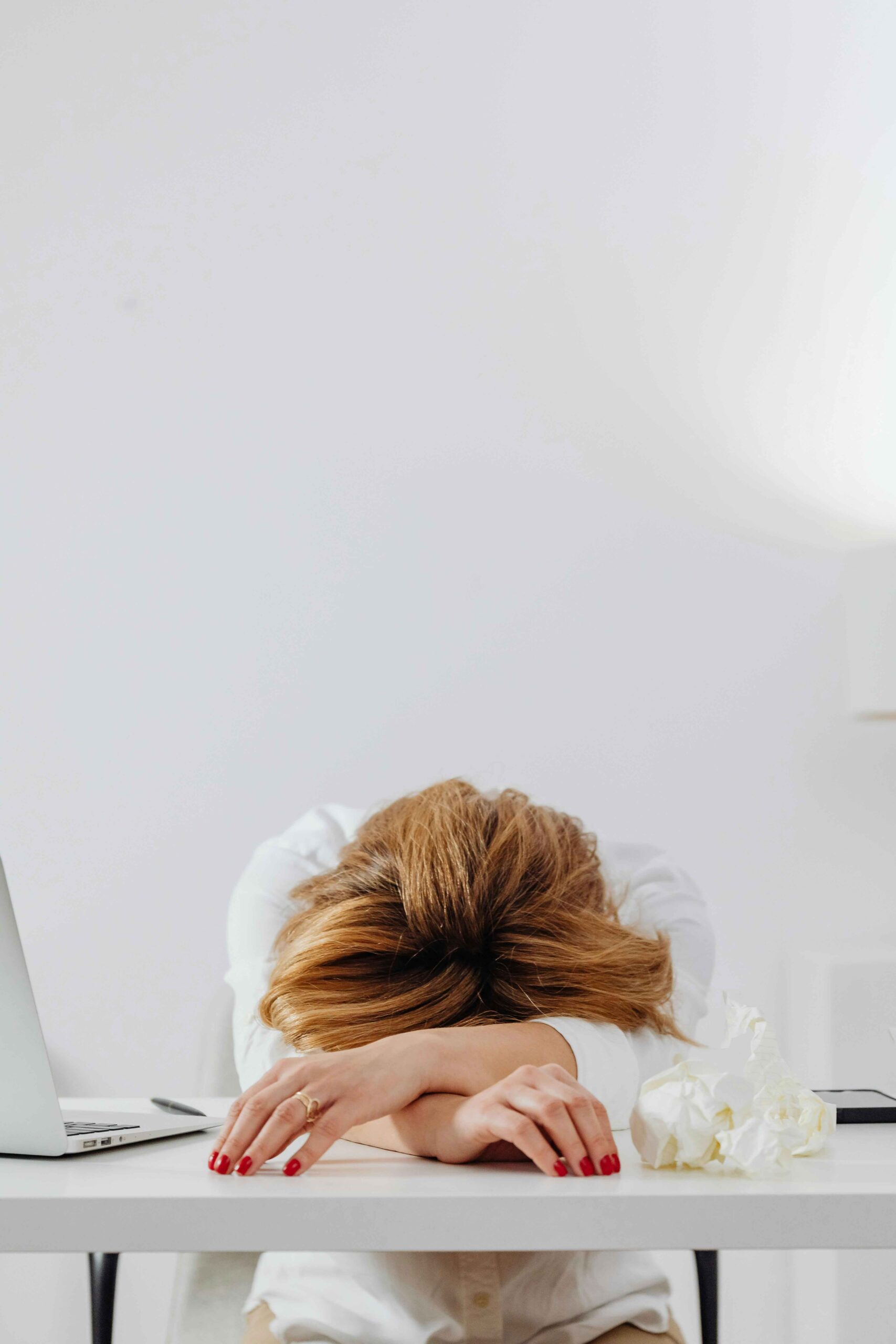 break through burnout. a woman with her head down on a desk