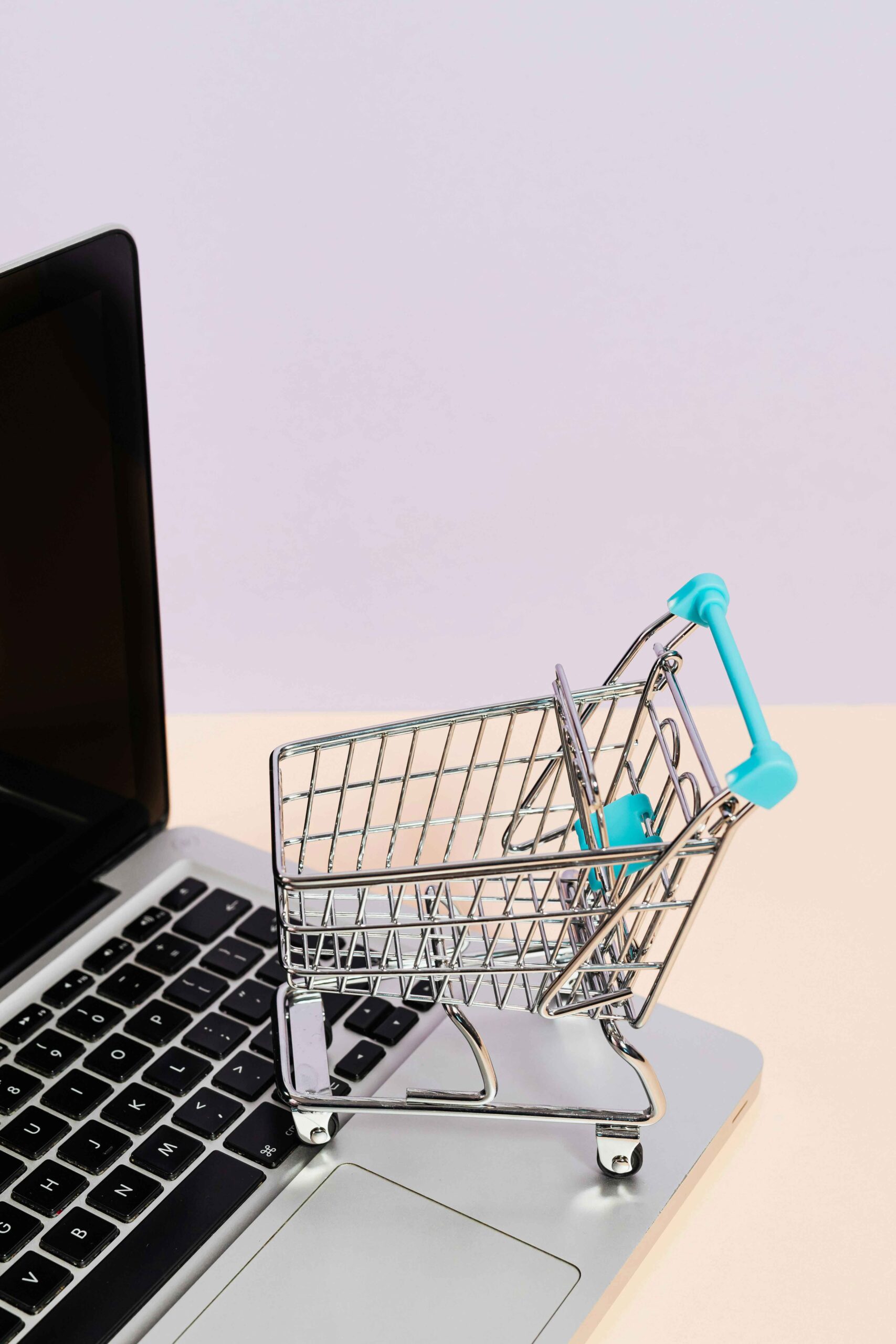 what is sales of product income - a tiny shopping cart sitting on top of a lap top keyboard